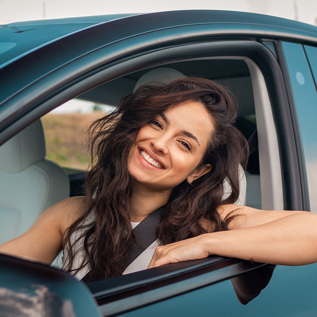 Person smiling inside a car