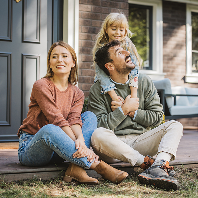 Family sitting on porch outside