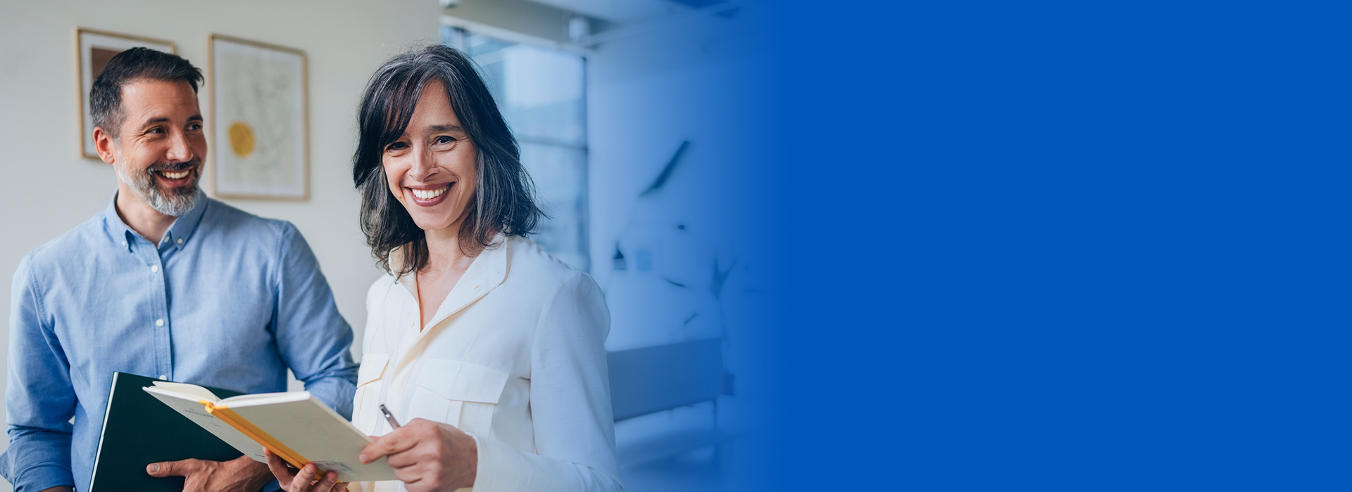 Smiling people holding notebooks